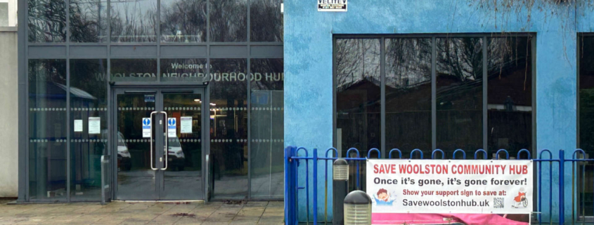 Entrance to Woolston Neighbourhood Hub with a banner reading "Save Woolston Community Hub" on the fence outside.